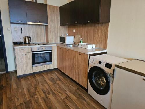 a kitchen with a washing machine and a washer at Europroperties Yalta Apartments in Golden Sands