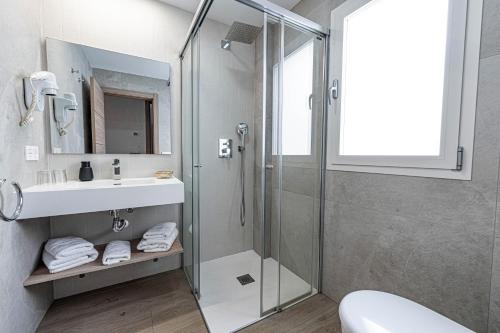 a bathroom with a shower and a sink at Hostal Boutique Aurora in Nerja