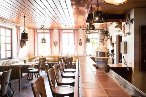 - un restaurant avec des tables et des chaises dans une salle dans l'établissement Gasthof Isernhagen, à Gödenstorf
