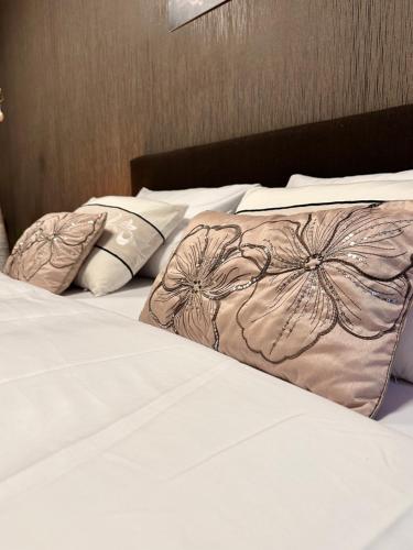 a bed with two pillows on top of it at Apartmán Leonardo - city center in Trnava
