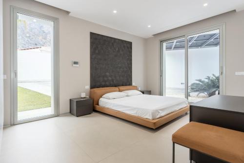 מיטה או מיטות בחדר ב-Villa Tritone
