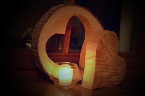 a candle in a glass in front of a mirror at Haus Bergfrieden in Lermoos