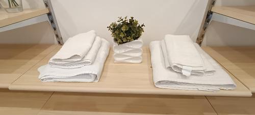 three towels are sitting on a shelf in a bathroom at Casa di Nonna Margherita in Trecase