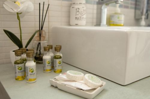 a counter with several bottles of soap and a sink at Casa Vacanze Family House posizione centralissima in Civitavecchia