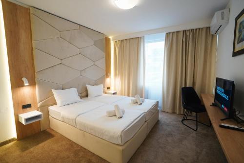En eller flere senge i et værelse på Hotel Sumadija