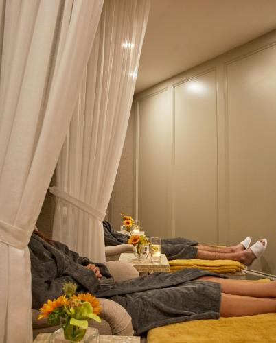 two people laying on beds in a room at County Arms Birr in Birr