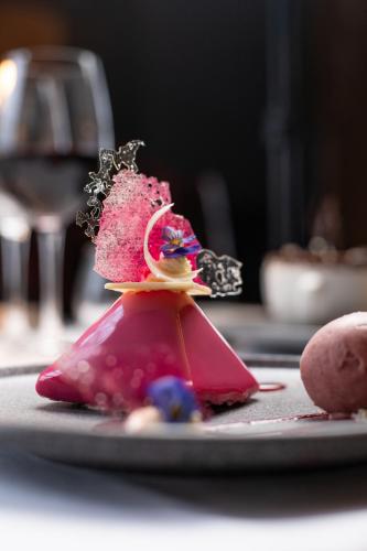 a piece of cake on a plate with a glass of wine at County Arms Birr in Birr