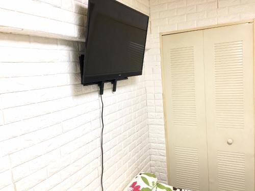 a flat screen tv hanging on a wall at 4 minute walk to station. Direct to Shibuya and Shinjuku in 35minutes in Nishi-tsuruma