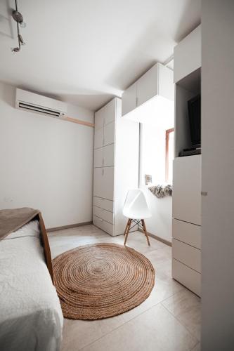 a bedroom with a bed and a rug on the floor at Apartma Tuna in Izola