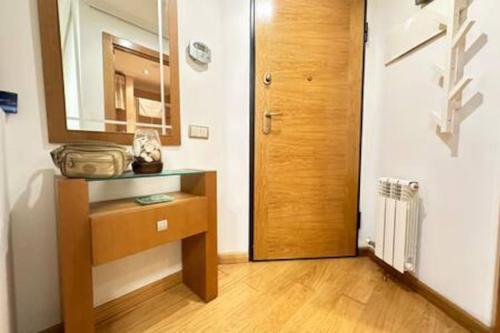 a room with a wooden cabinet and a mirror and a door at Luxury Suite Premium Heart Vigo in Vigo