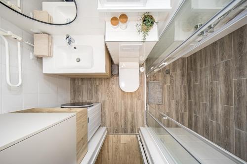 a small bathroom with a sink and a mirror at SMILGA & KOPA home - Mano jūra 2 Kunigiškiai - by Hello Sea homes in Palanga