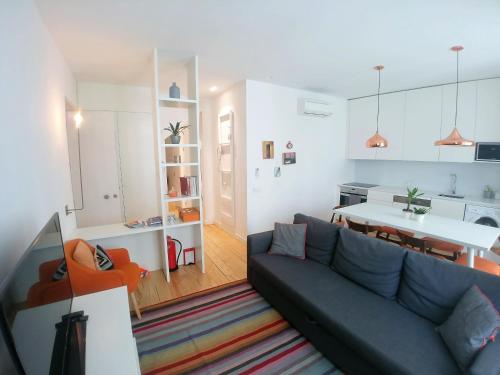 a living room with a couch and a table at Be Local - 2 bedrooms in front of the Fado Museum in Alfama in Lisbon
