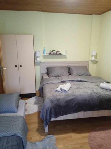 a bedroom with a large bed with towels on it at Krpan in Belišće