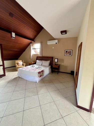 a bedroom with a large bed in a room at Pousada Finlândia in Penedo