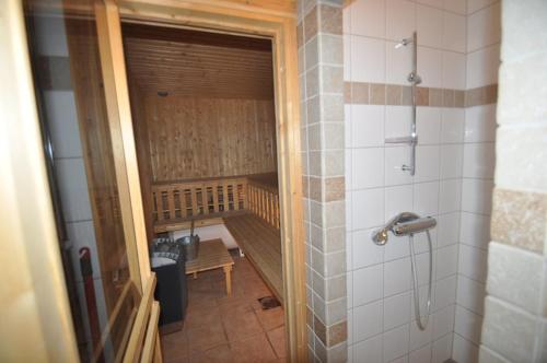 a bathroom with a walk in shower next to a bench at Stärhusvägen 6B in Sälen