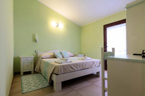a small bedroom with a bed and a window at Sardinia for you in Oristano