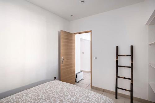 a bedroom with a bed and a closet and a ladder at Entre Aix et Marseille in Rognac