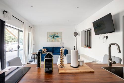 a kitchen and living room with a blue couch at Entre Aix et Marseille in Rognac
