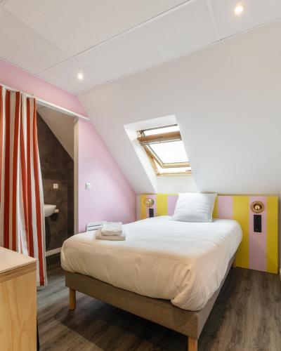 a bedroom with a large bed in a room at DEMAIN Hôtel in Nantes