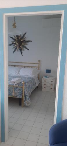 a bedroom with a bed with a flower on the wall at Belview Positano in Positano