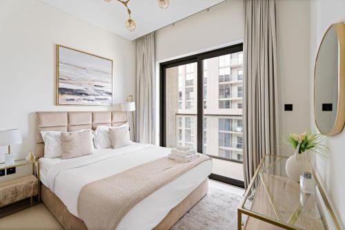a bedroom with a large bed and a large window at Beautiful 2 bedroom next to Business Bay - Sobha Creek Vista in Dubai
