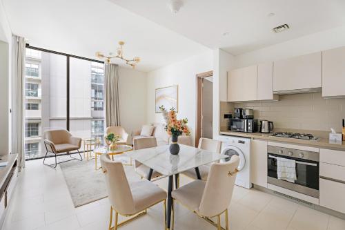 a kitchen and dining room with a table and chairs at Beautiful 2 bedroom next to Business Bay - Sobha Creek Vista in Dubai