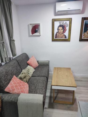 a living room with a couch and a coffee table at Apartamento Gitanilla in Chipiona