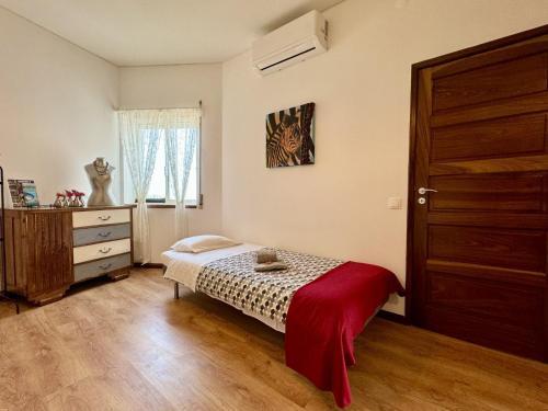 a bedroom with a bed and a dresser and a window at Alegria Apartment Porto Downtown in Porto