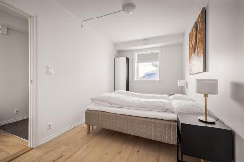 a bedroom with a bed and a table and a window at Gullstein in Geilo