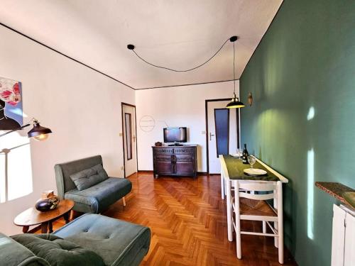 a living room with a couch and a table at Clio Apartment in Verbania