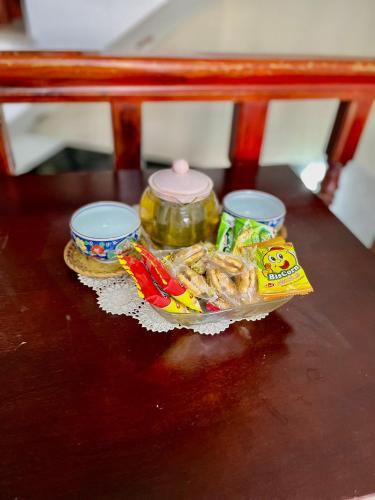 a table with some food and a jar on it at Cherry Homestay - Hoàng Đế motel in Chau Doc