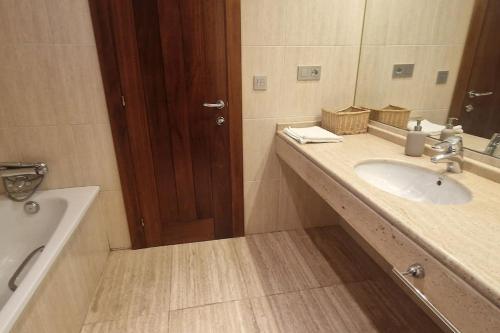 a bathroom with a sink and a mirror at 1A119 El Sangar Somio in Gijón