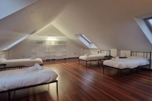 a room with four beds in a attic at 1A119 El Sangar Somio in Gijón