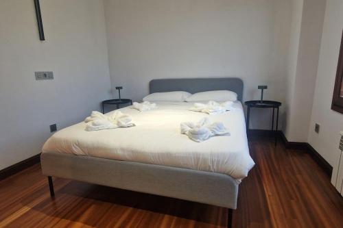 a bedroom with a bed with towels on it at 1A119 El Sangar Somio in Gijón