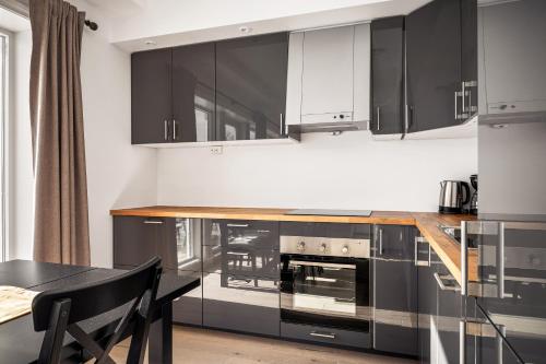 a kitchen with black and white cabinets and a table at Gullstein in Geilo