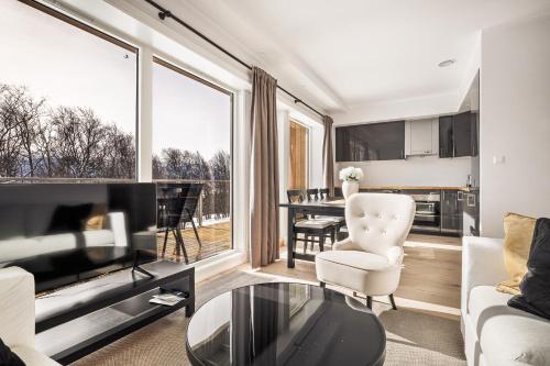 a living room with a couch and a table at Gullstein in Geilo