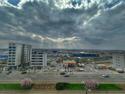 a view of a parking lot with a rainbow in the sky at Fancy Apartament Promenada Mall in Craiova