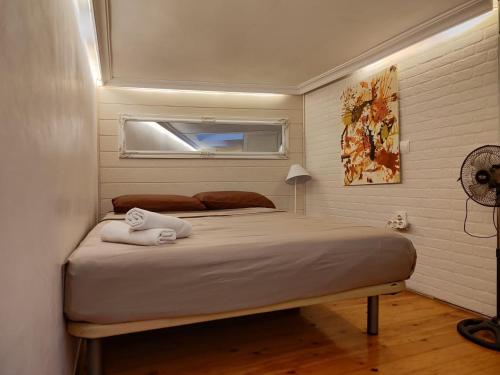 a bedroom with a bed with two towels on it at Mini duplex plaza mayor in Madrid