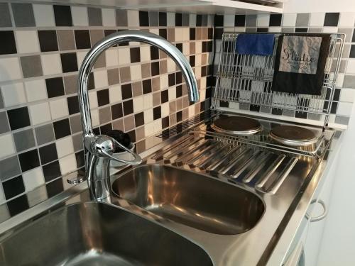 a sink in a kitchen with a faucet at Studio close to Malmö and Lund in Åkarp