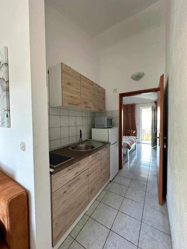 a kitchen with a sink and a counter top at Apartments Natalika in Podaca