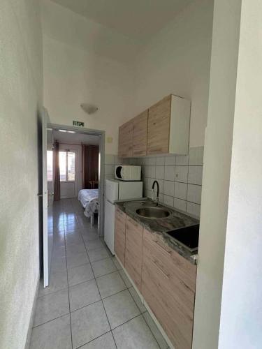 a kitchen with a sink and a counter top at Apartments Natalika in Podaca