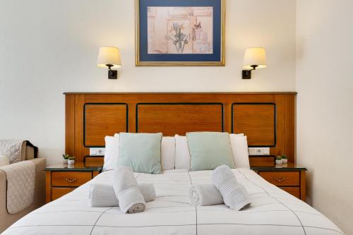 a bedroom with a white bed with two pillows at Solana Fuengirola 40 in Fuengirola