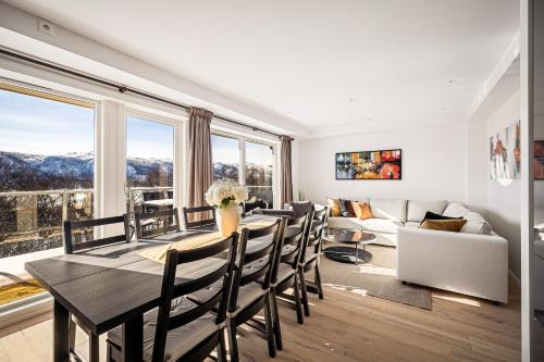 a dining room with a table and chairs and a couch at Gullstein in Geilo