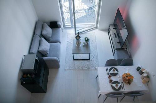 a living room with a table and a couch at Elegant Penthouse Loft - Near the Airport in Vantaa