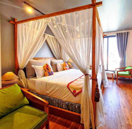 a bedroom with a canopy bed with curtains at Hotel Nova Boutique in Rajkot