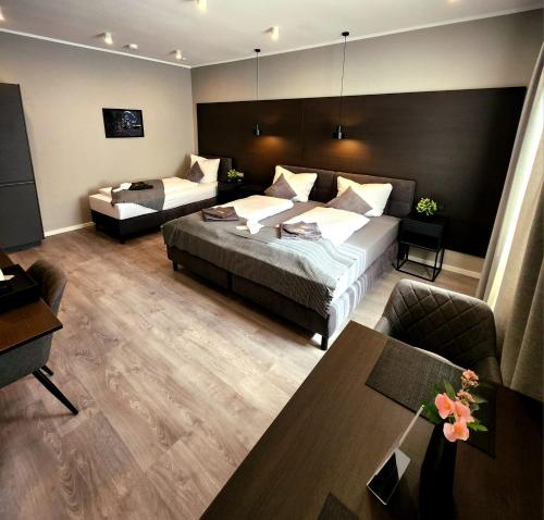 a hotel room with a bed and a couch at Liro Hotel Oberhausen in Oberhausen
