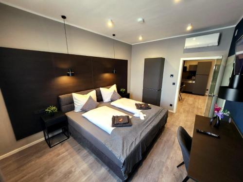 a bedroom with a large bed and a desk at Liro Hotel Oberhausen in Oberhausen