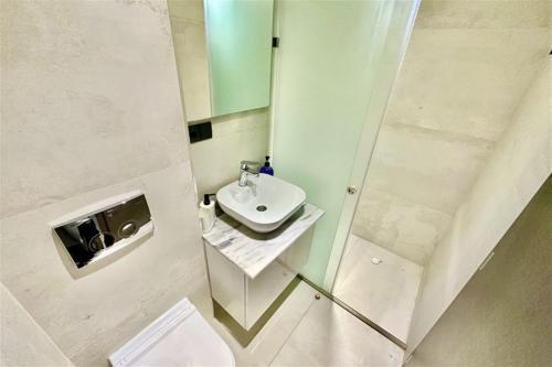 a small bathroom with a sink and a mirror at White Lion Apartment N2 Kallithea in Kallithea Halkidikis