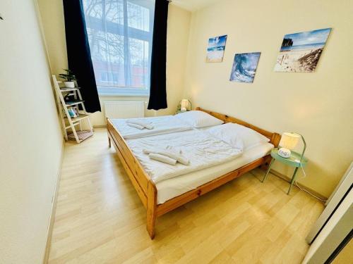 a bedroom with a bed in a room with a window at WarneSonne in Warnemünde