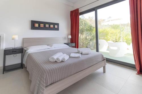 a bedroom with a bed with towels on it at Natur Hotel Tanca in Cardedu